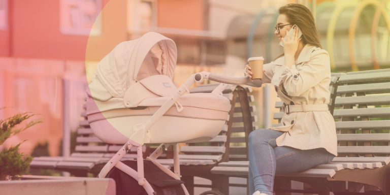 a mom sitting on bench with baby in stroller