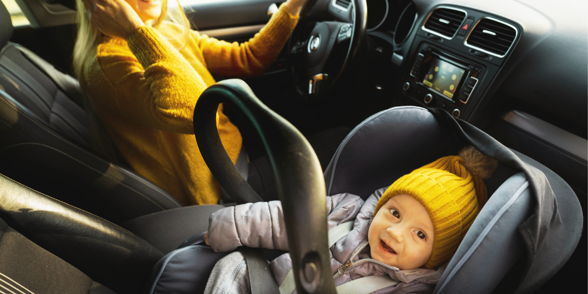 a baby in car seat with his mom