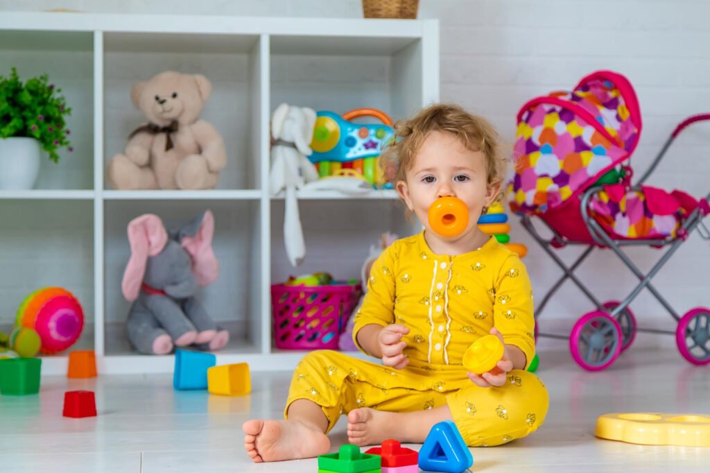 A nursery filled with baby toys, a cot and soft furnishings